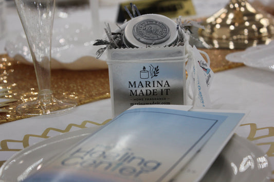 Handcrafted candle favors from Marina Made It displayed at the Hats and Heels for Healing event in Jensen Beach, Florida